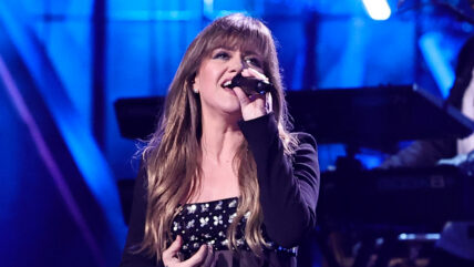 Kelly Clarkson singing on stage at an event in 2024