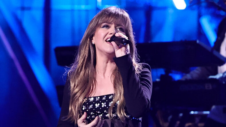 Kelly Clarkson singing on stage at an event in 2024