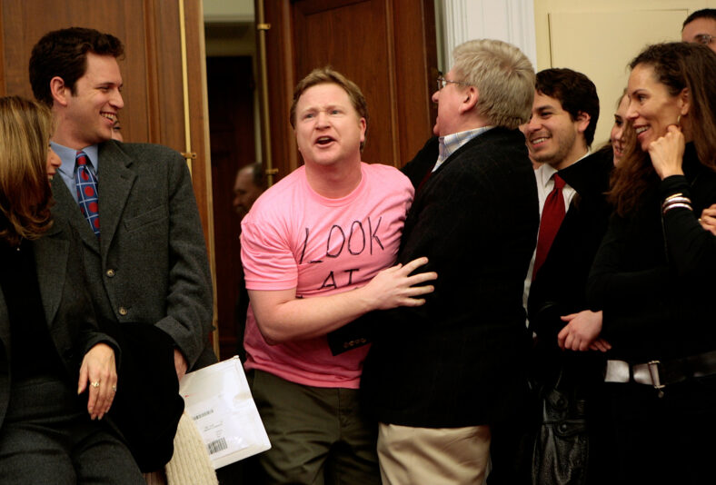 : Writers Guild of America member and Daily Show writer Kevin Bleyer is dragged out of a hearing room by WGA President Michael Winship after imitating a Code Pink demonstrator during a comedic mock debate and news conference about the writers strike on Capitol Hill January 23, 2008 in Washington, DC. Members of Congress met with representatives of the WGA to talk about their current strike over the minimum basic agreement which sets the amount that companies must pay writers for the use and re-use of their work. 