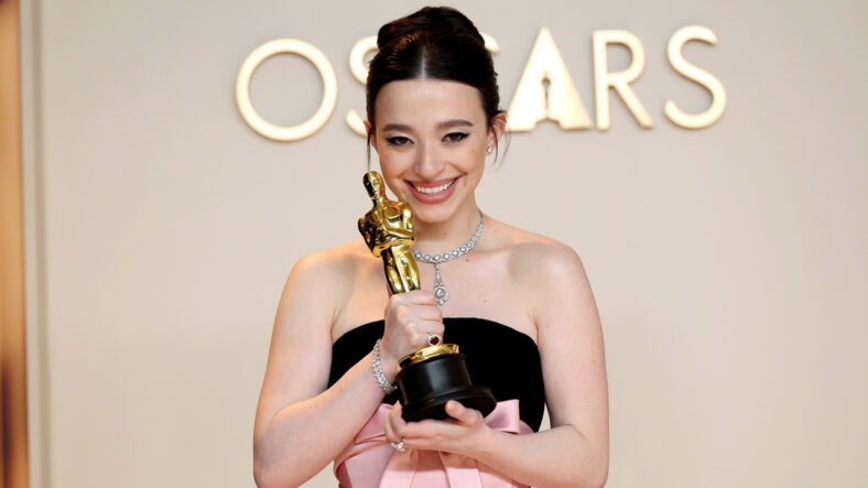 Mikey Madison smiles while holding her Oscar statue after her 2025 win