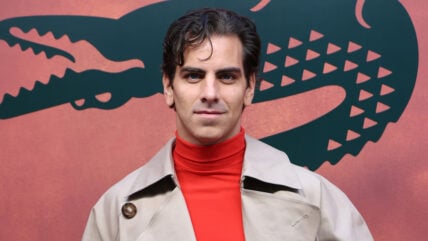 Nyle DiMarco poses at the Lacoste fashion show in Paris