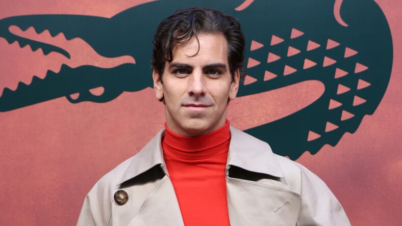 Nyle DiMarco poses at the Lacoste fashion show in Paris