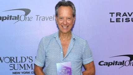 Richard E. Grant in a blue shirt at a Capital One event.