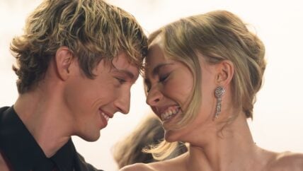 Troye Sivan and Lily-Rose Depp smiling holding heads together