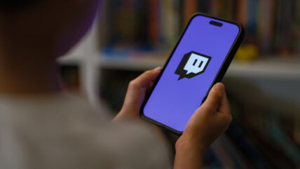 Twitch logo on someone's cell phone.
