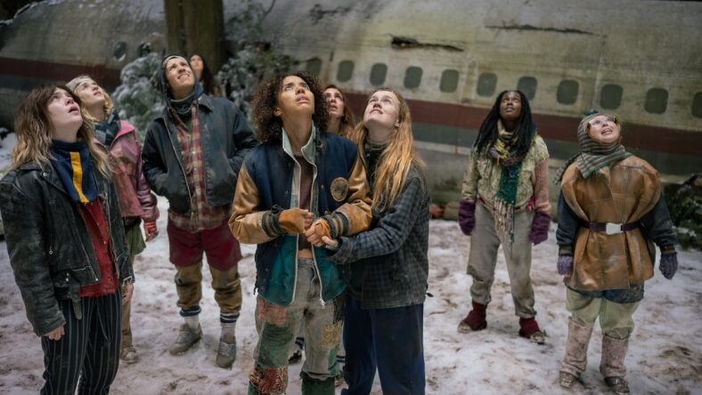 Yellowjackets Season 4 still Sophie Thatcher as Teen Natalie, Jenna Burgess as Teen Melissa, Kevin Alves as Teen Travis, Courtney Eaton as Teen Lottie, Jasmin Savoy Brown as Teen Taissa, Sophie Nélisse as Teen Shauna, Liv Hewson as Teen Van, Nia Sondaya as Teen Akilah and Samantha Hanratty as Teen Misty in Yellowjackets